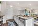 Kitchen island featuring stainless steel appliances, white cabinets and decorative lighting at 2405 Horse Shoe Cir, Fort Lupton, CO 80621