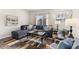 Cozy living room with a large window, comfortable seating, and stylish decor at 2405 Horse Shoe Cir, Fort Lupton, CO 80621