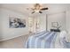 Main bedroom featuring an ensuite bathroom and a large window at 2405 Horse Shoe Cir, Fort Lupton, CO 80621