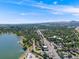 Expansive aerial shot of a lakefront community featuring tree-lined streets and views of a bustling commercial district at 1810 Youngfield Ct # A, Golden, CO 80401