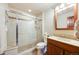 Neutral-toned bathroom with a glass-enclosed shower, vanity with wood cabinets, and modern fixtures at 1810 Youngfield Ct # A, Golden, CO 80401