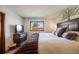 Comfortable bedroom with decorative accent and a large window providing ample natural light at 1810 Youngfield Ct # A, Golden, CO 80401