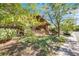 Charming exterior view showcasing a two-story home with a well-manicured lawn and mature trees at 1810 Youngfield Ct # A, Golden, CO 80401