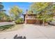 Charming two-story home featuring a balcony, multi-car garage, and mature trees creating a welcoming curb appeal at 1810 Youngfield Ct # A, Golden, CO 80401