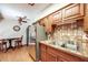 Bright kitchen featuring wooden cabinets, stainless steel appliances, tile countertops, and a breakfast table at 1810 Youngfield Ct # A, Golden, CO 80401