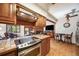 Bright kitchen featuring wooden cabinets, tile countertops, stainless steel appliances, and view of the living room at 1810 Youngfield Ct # A, Golden, CO 80401