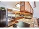 Bright kitchen featuring wooden cabinets, stainless steel appliances, tile countertops, and a skylight at 1810 Youngfield Ct # A, Golden, CO 80401