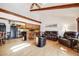 Open-concept living area featuring vaulted ceilings, exposed beams, a breakfast bar and comfortable seating at 1810 Youngfield Ct # A, Golden, CO 80401
