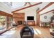 Spacious living room with vaulted ceilings, brick fireplace, hardwood floors and access to the outside deck at 1810 Youngfield Ct # A, Golden, CO 80401