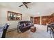 Well-lit living room with comfortable seating, lots of natural light, and an impressive ceiling fan at 1810 Youngfield Ct # A, Golden, CO 80401