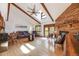 Bright living room with vaulted ceilings, exposed beams, a brick fireplace, and hardwood floors at 1810 Youngfield Ct # A, Golden, CO 80401