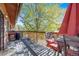 Outdoor patio showing table, chairs, umbrella, grill, and mature landscaping at 1810 Youngfield Ct # A, Golden, CO 80401