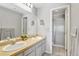 Bright bathroom featuring double sinks, ample counter space, and a separate shower room at 920 E Plum Creek Pkwy # 306, Castle Rock, CO 80104