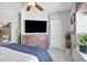 Bedroom featuring a dark wooden dresser with a wall mounted television above, stylish decor and a ceiling fan at 920 E Plum Creek Pkwy # 306, Castle Rock, CO 80104