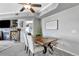 Cozy dining area features a custom wood table, a modern ceiling fan, and views into the adjacent room at 920 E Plum Creek Pkwy # 306, Castle Rock, CO 80104