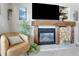 Cozy living room featuring a fireplace, comfortable armchair, and stylish decor at 920 E Plum Creek Pkwy # 306, Castle Rock, CO 80104