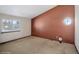 Bedroom with unique circular window and tan walls at 11080 W Walker Dr, Littleton, CO 80127