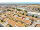 An aerial view shows townhomes near commercial spaces and surrounding neighborhoods at 2616 E Egbert St, Brighton, CO 80601