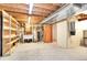 Unfinished basement with concrete floor, shelving, wooden framing, and utility hookups at 2616 E Egbert St, Brighton, CO 80601