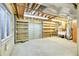 Unfinished basement with concrete floor, shelving, wooden framing, and utility hookups at 2616 E Egbert St, Brighton, CO 80601