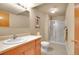 Bathroom features a vanity, toilet, and a glass-enclosed shower stall at 2616 E Egbert St, Brighton, CO 80601