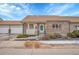 Charming single story brick home featuring an attached two car garage and manicured front yard at 2616 E Egbert St, Brighton, CO 80601