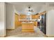 Well-lit kitchen with a ceiling fan, central island, and matching black appliances and cabinets at 2616 E Egbert St, Brighton, CO 80601