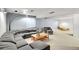 Finished basement living room with light gray carpet, plush seating, and modern lighting fixture at 2616 E Egbert St, Brighton, CO 80601