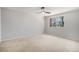 A bedroom featuring light-colored walls, neutral carpet, and a ceiling fan at 6527 S Ammons Ct, Littleton, CO 80123