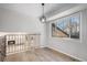 Cozy dining area with hardwood floors, stylish lighting, and a view of the lower level fireplace at 6527 S Ammons Ct, Littleton, CO 80123