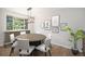 Bright dining room with stylish artwork and modern lighting fixture over a wooden round table at 6527 S Ammons Ct, Littleton, CO 80123