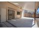 Covered patio featuring a ceiling fan, concrete flooring, and sliding glass doors into the home at 6527 S Ammons Ct, Littleton, CO 80123