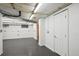 Clean, unfinished basement area with white walls, gray flooring, and exposed ceiling fixtures at 2541 Cherry St, Denver, CO 80207