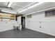 Unfinished basement with a utility sink and exposed pipes and fixtures against white walls at 2541 Cherry St, Denver, CO 80207