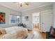 Bright bedroom with hardwood floors, window, closet, and ensuite bathroom at 2541 Cherry St, Denver, CO 80207