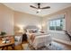 Cozy bedroom with a ceiling fan, window, and desk, featuring a bed with decorative pillows at 2541 Cherry St, Denver, CO 80207