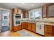 Modern kitchen featuring wood cabinets, stainless steel appliances and window with natural light at 2541 Cherry St, Denver, CO 80207