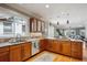 Open concept kitchen area with wood cabinets, granite countertops, stainless steel appliances, and hardwood floors at 2541 Cherry St, Denver, CO 80207