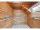 Wood-paneled storage room with hooks and a tile floor and a sloped ceiling at 2541 Cherry St, Denver, CO 80207