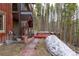Backyard with elevated deck featuring hot tub and swing offers stunning forest views for outdoor relaxation at 167 Independence Cir, Breckenridge, CO 80424