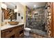 Charming bathroom shows stone vessel sink, wood accents, and a tile-clad glass shower at 167 Independence Cir, Breckenridge, CO 80424