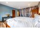 Charming bedroom with a birch tree mural feature wall and hardwood floors creates a cozy and unique retreat at 167 Independence Cir, Breckenridge, CO 80424