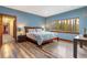 Bedroom featuring blue walls, hardwood floors, and natural light offers a relaxing and inviting atmosphere at 167 Independence Cir, Breckenridge, CO 80424