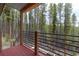 Outdoor deck with metal railing overlooking a forest at 167 Independence Cir, Breckenridge, CO 80424