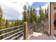 Deck features metal railings, wood posts and a stunning forest view with blue skies at 167 Independence Cir, Breckenridge, CO 80424
