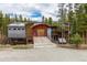 Unique exterior elevation shows a wood-accented home with garage door and luscious surrounding landscape at 167 Independence Cir, Breckenridge, CO 80424