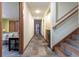 Hallway with tile flooring, wood trim, staircase, mini-fridge, and recessed lighting provides a functional and stylish transition space at 167 Independence Cir, Breckenridge, CO 80424