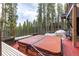 Exterior deck area featuring a hot tub with forest and mountain views and custom wood accents at 167 Independence Cir, Breckenridge, CO 80424