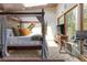 Comfortable main bedroom offers a canopy bed, desk, and expansive windows to enjoy the view at 167 Independence Cir, Breckenridge, CO 80424