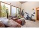 Sitting area with cozy furniture, large windows showcasing forest views, and a stationary bike at 167 Independence Cir, Breckenridge, CO 80424
